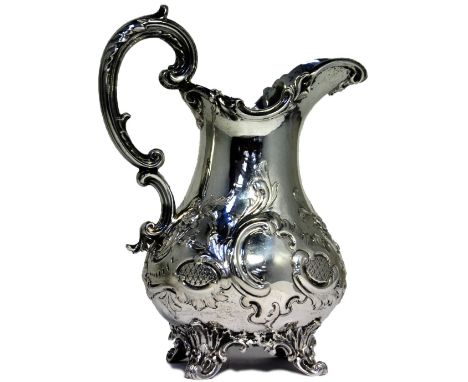 A Victorian hallmarked silver jug with repoussé decoration and high scrolling handle, height 18cm, London C.1844, approx weig