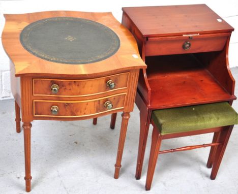 A reproduction yew wood occasional table the serpentine shaped top with leather inset top above two drawers also a telephone 