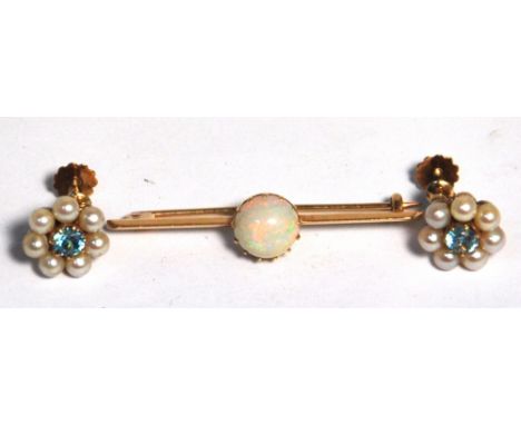 A yellow metal bar brooch set with an opal, a pair of 9ct gold clip on earrings set with central pale blue stones and pearls,