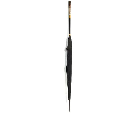 A vintage ladies umbrella with mother of pearl and yellow metal handle.