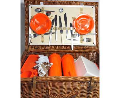 A vintage wicker picnic hamper complete with cups, saucer etc.