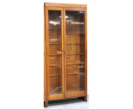 A large 20th century light oak and glazed double door display cabinet with interior glass shelves, width 100cm (af). CONDITIO