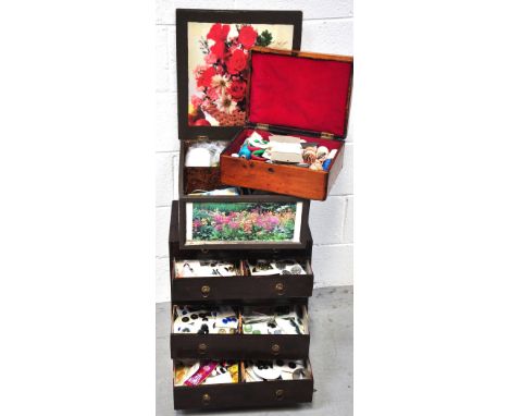 A small early 20th century wood chest with card drawers containing a large quantity of vintage buttons, a wooden sewing box w