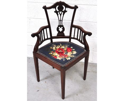 An Edwardian carved mahogany Chippendale revival corner chair on square supports.