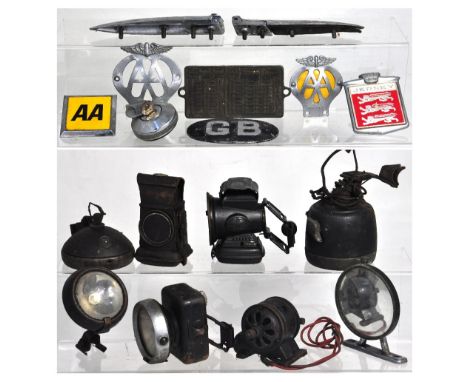 A quantity of motoring memorabilia to include vintage AA car badges, vintage head lamps, motor cycle lamps, 1960s vintage Gla