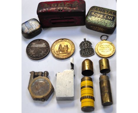 A mixed collectors lot to include a vintage cash tin, school attendance medals, an ARP badge, homemade cigarette lighters etc
