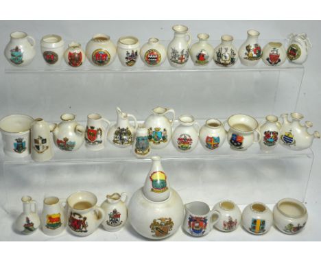 Approximately thirty pieces of Crested ware to include examples by W.H. Goss, Carlton china and Victoria china and a W.H. Gos
