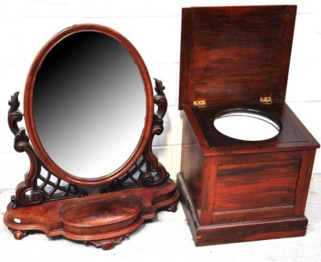 A late 19th early 20th century mahogany swing mirror on a shaped carved scrolling fretwork base and a mahogany commode (2).
