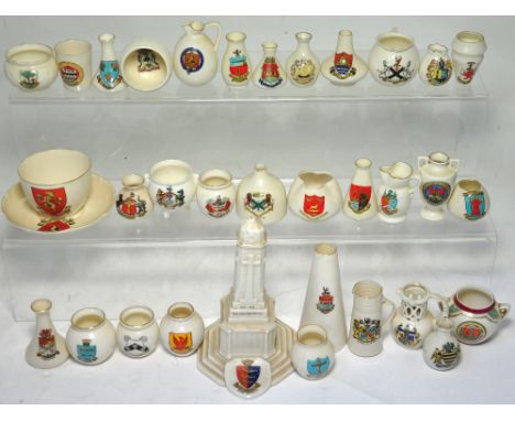 Approximately thirty pieces of Crested ware to include examples by W.H. Goss and a model of a cenotaph commemorating WW1.