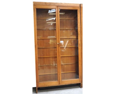 A large 20th century light oak and glazed double door display cabinet with interior glass shelves, width 100cm.