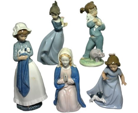 Four Nao figures, three of children, one a young girl holding a dog and one other figure of the Madonna.