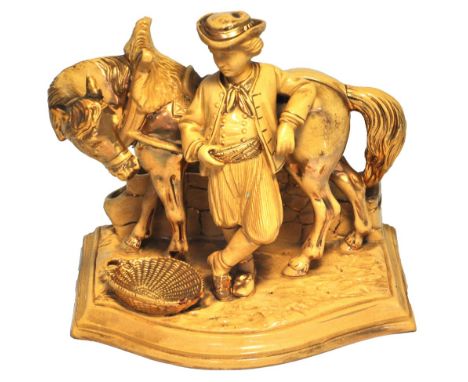 A late 19th century Eichwald gilt heightened glazed earthenware pipe holder modelled as a work horse with his attendant, heig