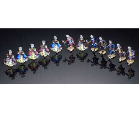 A SET OF TWELVE GILTMETAL AND ENAMEL PLACE STANDS IN THE FORM OF A LADY OR GALLANT, C1920  3.5cm h++Slight damage to enamel, 