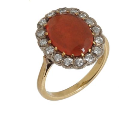 A FIRE OPAL RING with brilliant cut diamond surround, in gold marked 18ct, 6.5g, size P ++Fire opal has a chip, is exhibiting