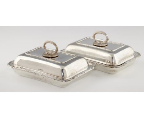 A PAIR OF GEORGE V SILVER ENTREE DISHES AND COVERS  with ribbon and reed rims, 28cm l, by Walker &amp; Hall, Sheffield 1917, 