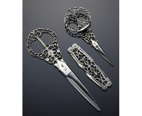 A SET OF THREE FINELY PIERCED STEEL NEEDLEWORK TOOLS, 19TH C  comprising four-bladed folding knife and two pairs of graduated
