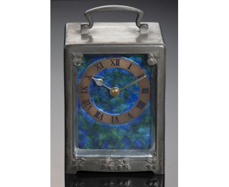 A LIBERTY &amp; CO PEWTER CARRIAGE CLOCK , C1910 with translucent enamel dial and copper and black enamel chapter ring, nicke