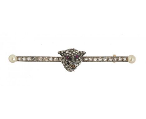 AN EDWARDIAN PAVE SET DIAMOND FOX HEAD BAR BROOCH, C1910 with ruby eyes, enamel teeth and pearl terminals, the rose cut diamo