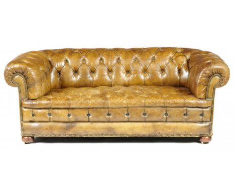 A VICTORIAN CHESTERFIELD SOFA, LATE 19TH C upholstered in buttoned and brass nailed hide, on mahogany bun feet with recessed 