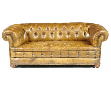 A VICTORIAN CHESTERFIELD SOFA, LATE 19TH C upholstered in buttoned and brass nailed hide, on mahogany bun feet with recessed 