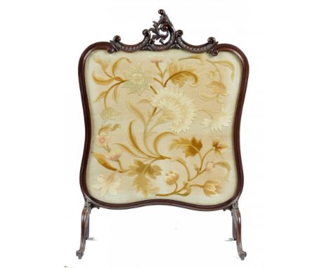 AN EDWARD VII CARVED MAHOGANY FIRESCREEN,  C1905  the embroidered banner worked in silk with a carnation and other flowers on