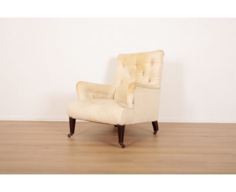 A COUNTRY HOUSE ARMCHAIRlate 19th/early 20th century, with worn button back damask covers, on tapered mahogany front legs and