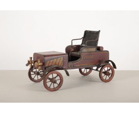 A METAL AND PAINTED WOODEN MODEL OF A VETERAN CAR gilt, brown and black livery, the seat upholstered in studded black vinyl, 