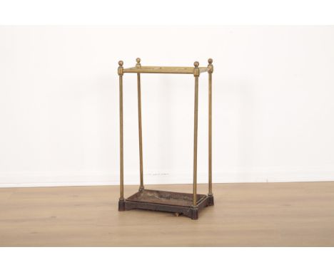 A LATE VICTORIAN BRASS AND CAST IRON STICK STAND19th century, with turned finials, 59cm high x 33cm wide x 21cm deepProvenanc