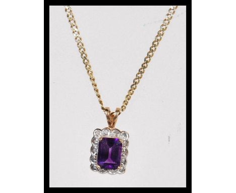 A 14ct gold curb link necklace chain having a hallmarked 9ct gold amethyst and diamond set necklace pendant. Chain measures 2