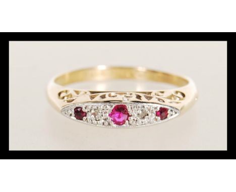 An 18ct gold stamped diamond and garnet stone ring having flush stone setting with scroll decorated mount. Weighs 1.9 grams s