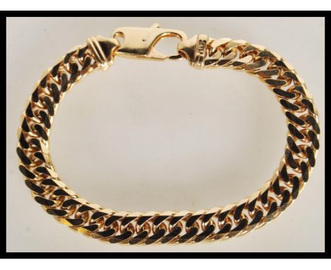A large and heavy hallmarked 9ct gold gents curb link bracelet chain having a lobster claw clasp. Weighs 47.1 grams measures 