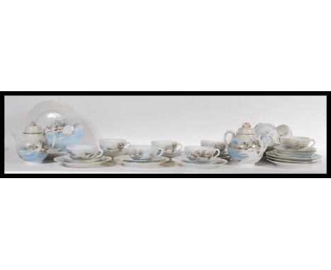 An early 20th Century Japanese Kutani ware eggshell porcelain tea service consisting of ten cups with saucers, ten smaller pl