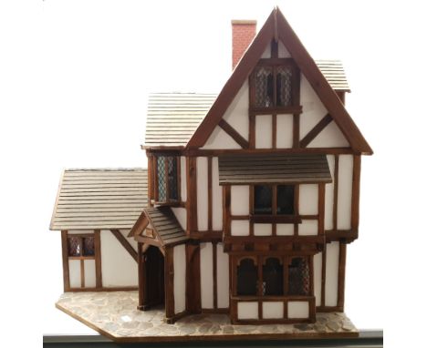 Gerry Welch for Manorcraft Tudor style wooden doll's house, of three-storey multi gabled form with mock beam and plaster wall