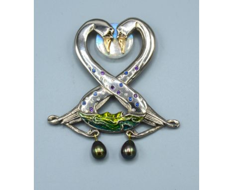 An 18ct. White Gold Pendant in the form of two swans set with diamonds, sapphires and amethysts with two grey pearl drops and