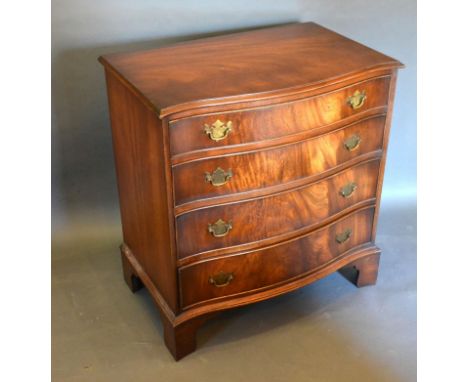 A Reproduction Mahogany Serpentine Fronted Chest of Drawers, the moulded top above four graduated drawers with brass drop han