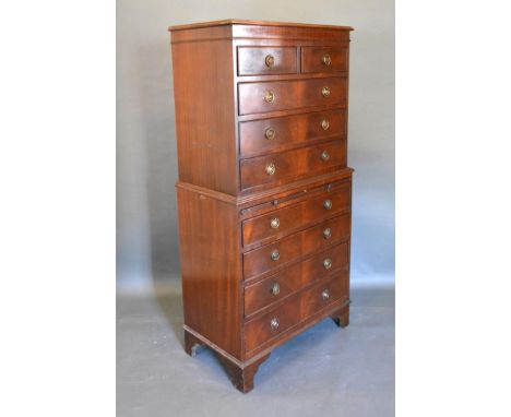 A Reproduction Mahogany Chest on Chest, the top section with moulded top and two short and three long drawers with circular b