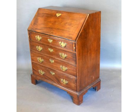 A 19th Century Mahogany Bureau, the fall front enclosing a fitted interior above four long drawers with brass handles and esc
