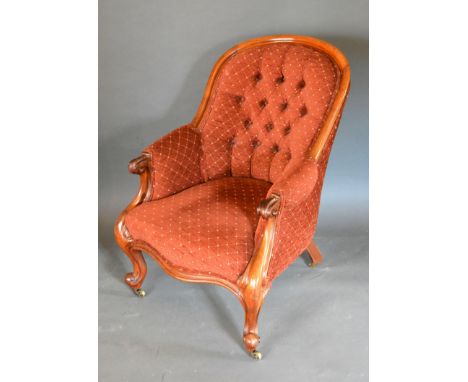 A Victorian Mahogany Drawing Room Armchair, the button upholstered back above a serpentine stuff over seat raised upon cabrio