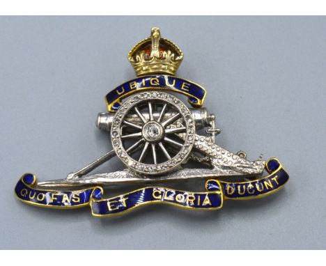 An 18ct. Gold Royal Artillery Brooch set with blue enamel and diamonds, 9.9 gms.