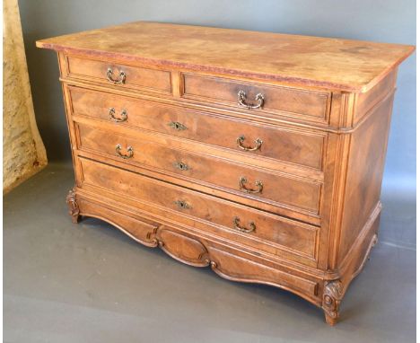A 19th Century French Commode with two short and three long drawers with brass handles and escutcheons raised upon carved scr