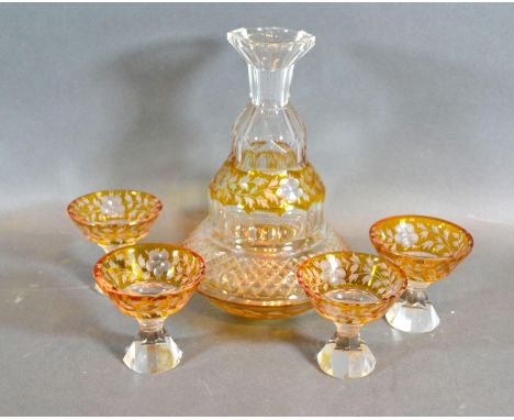 A Victorian Glass Drinking Set comprising a decanter and four small glasses engraved with foliate decoration upon a yellow gr