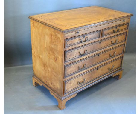 A 20th Century Chest, the moulded top above a brushing slide and two short and three long drawers with brass handles raised u