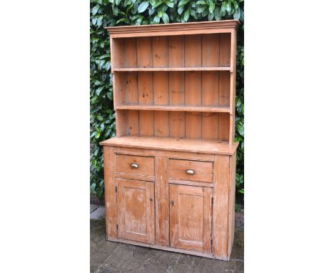 A Late 19th Early 20th Century Pine Dresser, the boarded shelf back above two drawers and two cupboard doors, 124 cms wide, 4