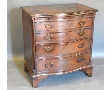 A Reproduction Mahogany Serpentine Fronted Chest of Drawers, the moulded top above a brushing slide and four long drawers wit