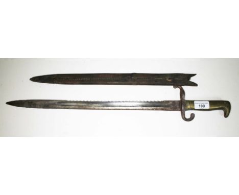 A German 1871 pattern saw back bayonet with brass handle, length of blade 46cm, handle 13cm.  Rust and pitting throughout, th