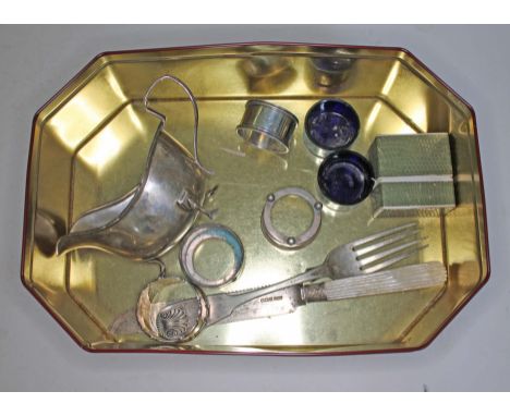 Assorted hallmarked silver comprising a sauce boat, a fork, a mother of pearl handle knife, a pair of salts and two serviette