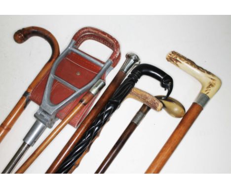 A bundle of six vintage canes including silver topped, horn, antler, African, a shooting stick and a swagger stick.  