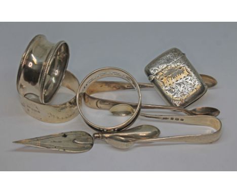 Hallmarked silver comprising a vesta, a novelty trowel book mark, two pairs of sugar tongs and three serviette rings, gross w