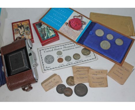 A box of collectables to include various coins to include USA, UK, 2 sets of trumps and a vintage Adox Golf foldable camera. 
