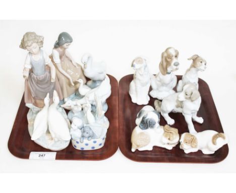 A group of twelve Nao figures to include seven dogs figures, three geese and two figures of women with geese.  All figures ar